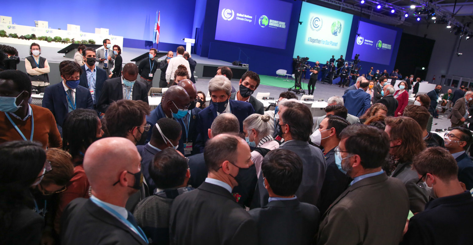 Delegates huddle at closing Plenary of COP26