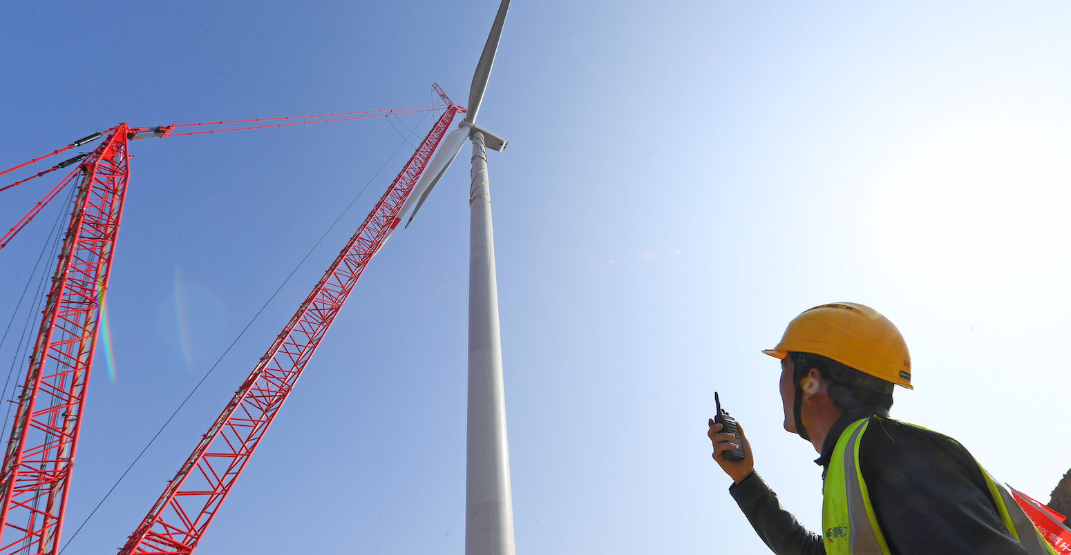 Technical workers installing equipment at Zhangpuying Wind Farm in Nanqiao District, Chuzhou City, Anhui Province, China
