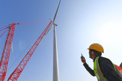 Technical workers installing equipment at Zhangpuying Wind Farm in Nanqiao District, Chuzhou City, Anhui Province, China