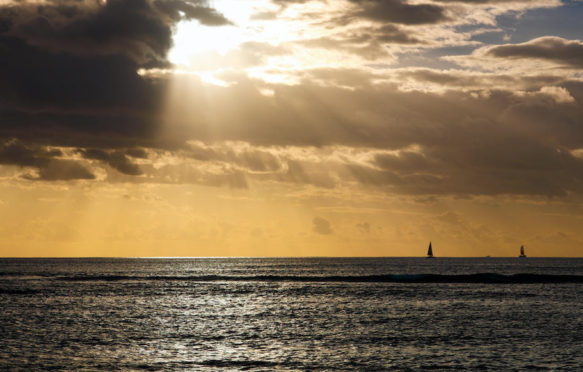 Afternoon clouds with sun rays over the Pacific ocean in Honolulu, Hawaii