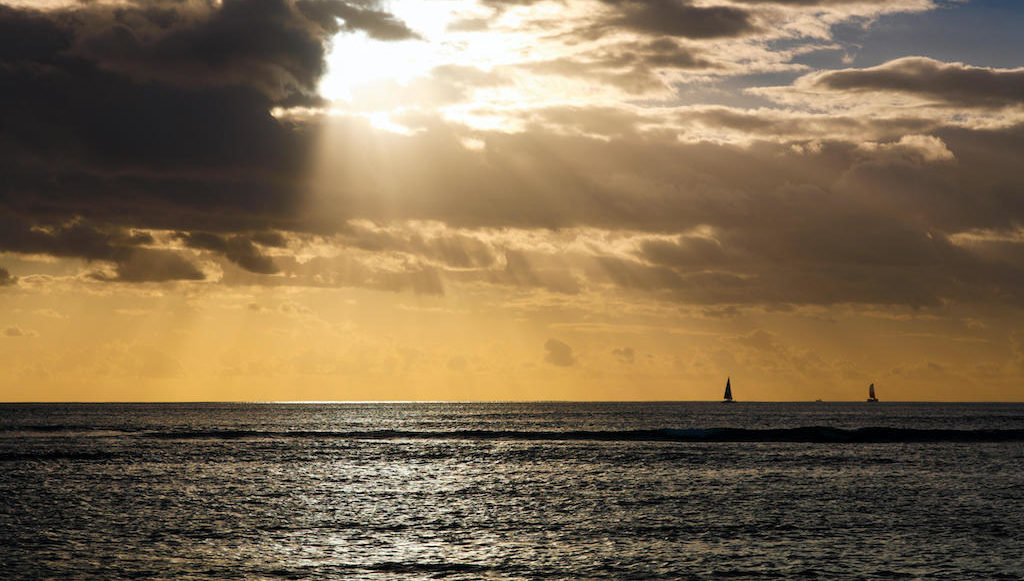 Afternoon clouds with sun rays over the Pacific ocean in Honolulu, Hawaii