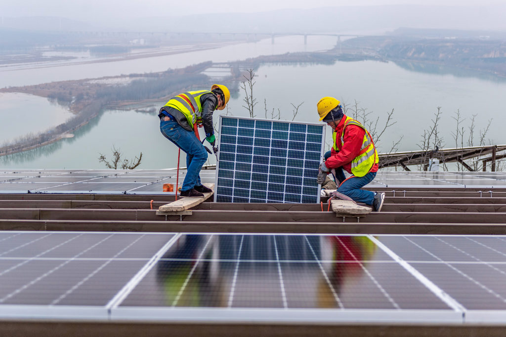 Workers installing solar panels in Yuncheng city’s Ruicheng county in Shanxi Province, northern China, on 7 January 2022. Credit: Oriental Image