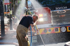 Fireman cooling off after battling a fire in hot weather in Montreal, Canada June 2021