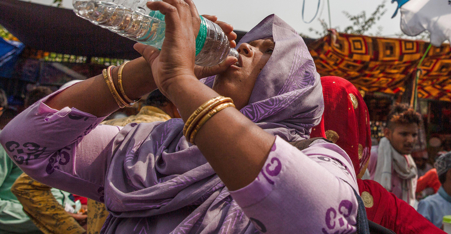 A woman drinks water during a hot day in New Delhi, April 29, 2022