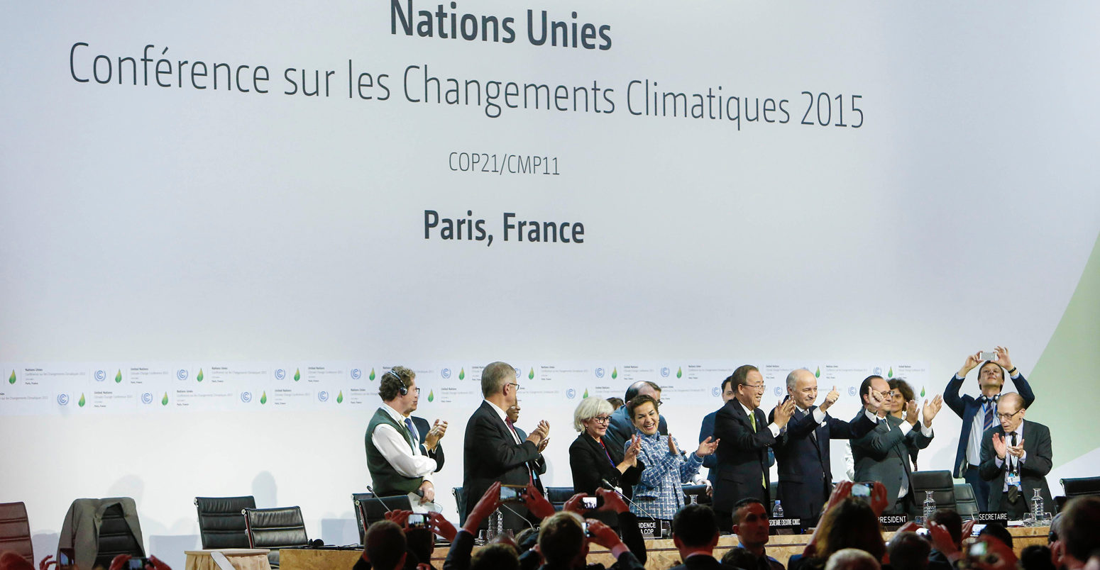 Leaders celebrate the adoption of the Paris Agreement during the final conference at COP21