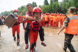 People are evacuated after heavy downpours in Zhengzhou, Henan, China, on 22 July 2021. Credit: Xinhua / Alamy Stock Photo. 2G8R652