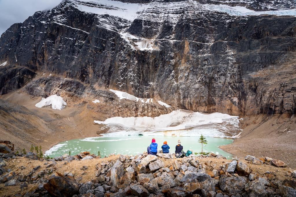 A mother and her two children overlooking a melting glacier at Edith Cavell Meadows, Jasper National Park, Canada, 26 September 2021.