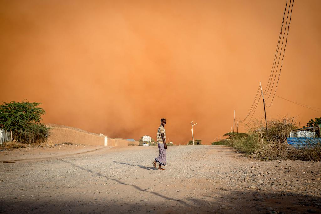 A man walks in front of a sandstorm in Dollow, Jubaland, Somalia, 14 April 2022.