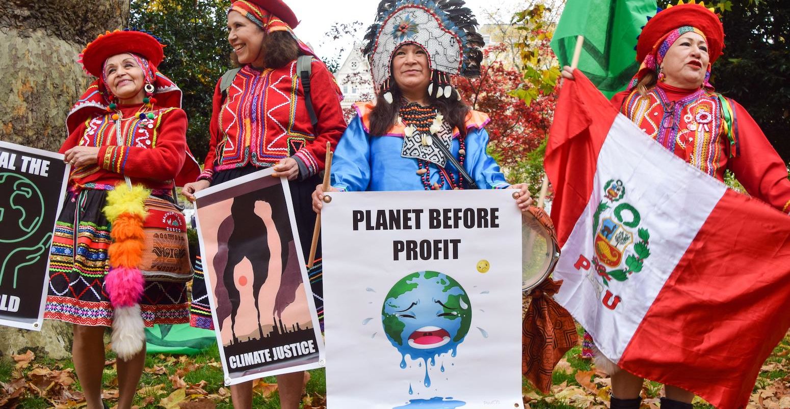 Indigenous protesters hold placards during a march in London