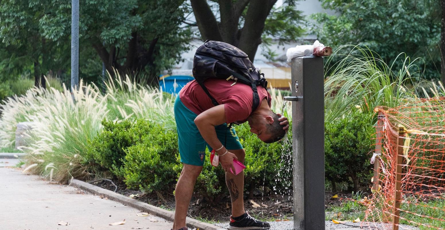 A young man refreshes himself at Giordano Bruno Square, City of Buenos Aires, during the January 2022 heat wave in Argentina.
