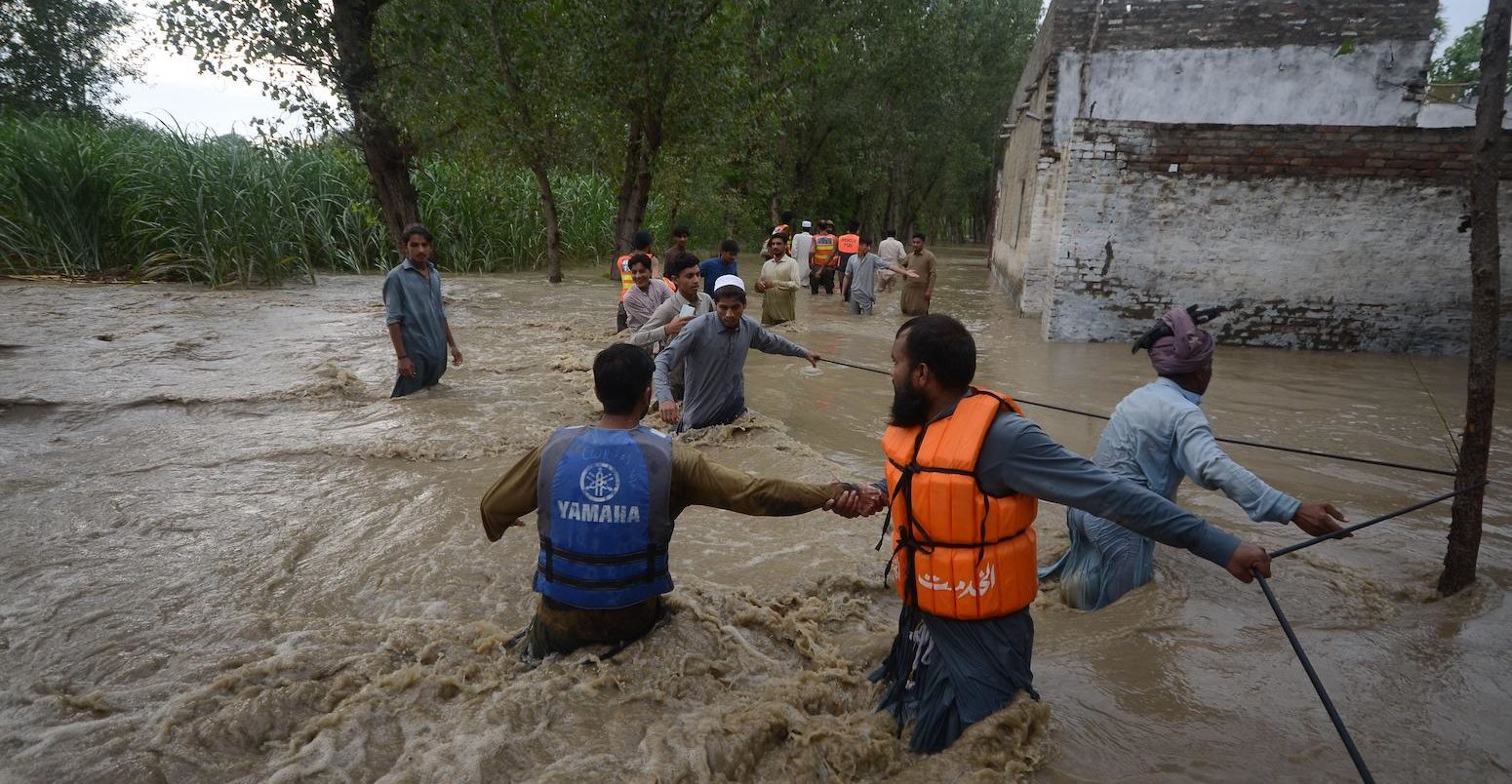 Citizens make their way through flooded streets with difficulty in the Dagai Mukaram Khan region, Pakistan.