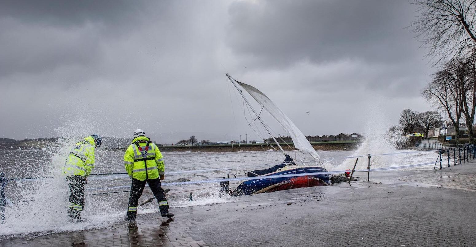 Yacht washed ashore and grounded during Storm Ciara at Cardwell Bay, Gourock, UK with H M Coastguard in attendance