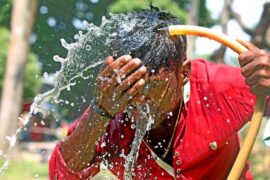 A person washes his face with water during high temperature weather day in Dhaka, Bangladesh, on April 11, 2023.
