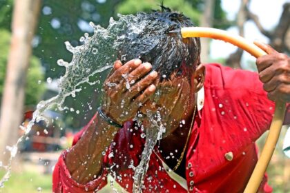 A person washes his face with water during high temperature weather day in Dhaka, Bangladesh, on April 11, 2023.