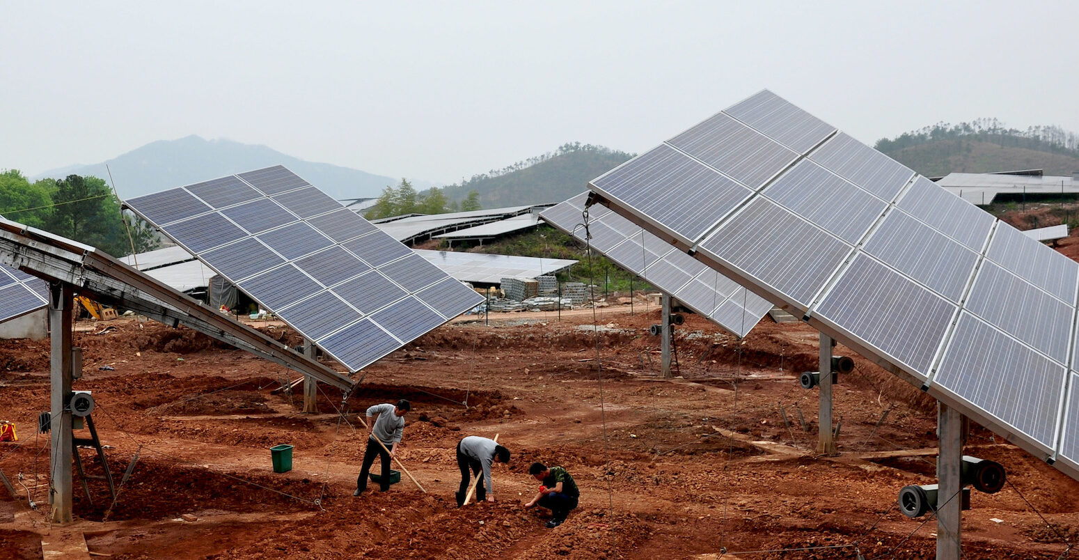 Villagers in Jiangxi province, China, plant peanuts in the open space of a 20MW solar photovoltaic power station.